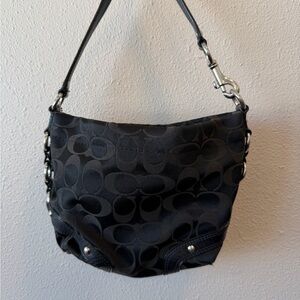Black monogrammed Coach shoulder bag with silver hardware